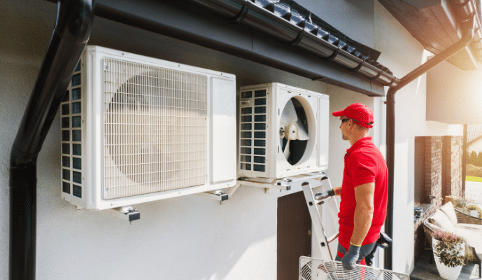 Man inspecting AC outdoor unit