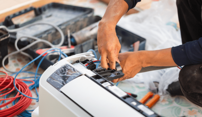 AC Technician fixing wiring