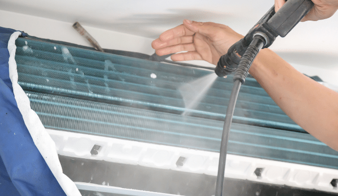 AC being cleaned with spray